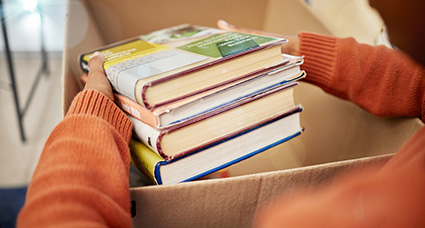 Support-the-Libraries putting books into a box to donate to the library